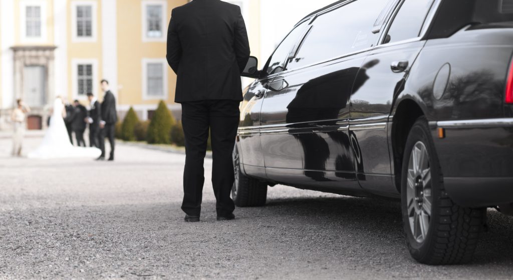 wedding car driver patiently waiting at the door